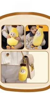Detail of cute banana plush pillow and mini keychain with expressive facial features