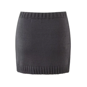 Detail of dark grey knit skirt showing ribbed edges and fine texture on white background