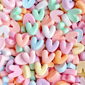 Close-up of colorful heart-shaped resin charms in pastel shades for DIY crafts