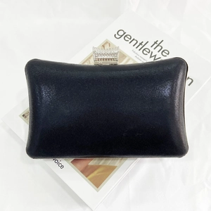 Elegant shimmer black evening clutch with silver rhinestone clasp on a fashion magazine