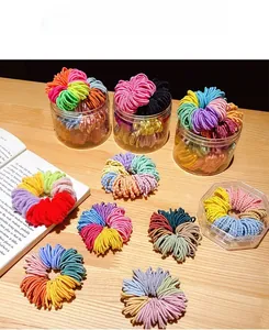 Close-up of high-elasticity colorful kids hair ties in transparent storage jars