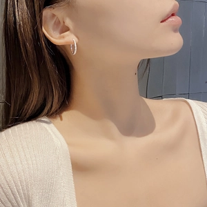 Sparkling S925 sterling silver hoop earrings with shimmering zircons worn by a model