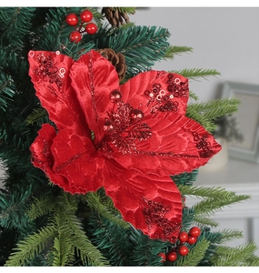 Macro shot of red glitter poinsettia with velvet petals on a festive Christmas tree