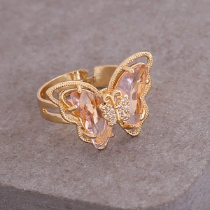 Golden butterfly ring featuring pink pear-shaped crystals and adjustable open band