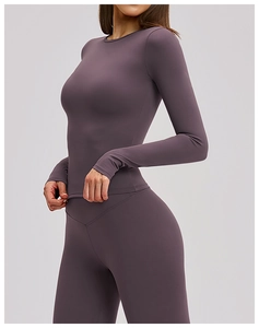 Detailed side view of purple long-sleeved yoga top and high-waisted fitness leggings