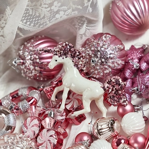 Pink Christmas tree ornament set featuring a white sequined unicorn and assorted baubles