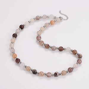 Detail of earth-tone agate beaded necklace with silver spacers and lobster clasp chain