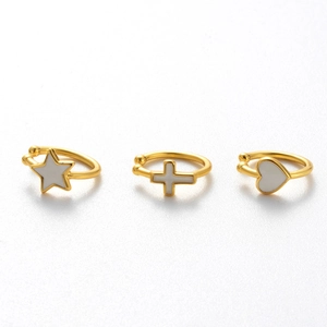 Three gold-plated cartilage ear clips featuring white enamel heart star and cross shapes