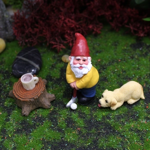 Christmas garden gnome playing golf with a puppy figurine landscape ornament