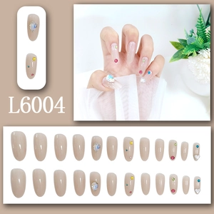 Elegant almond press-on nails with nude base color and colorful teardrop rhinestones
