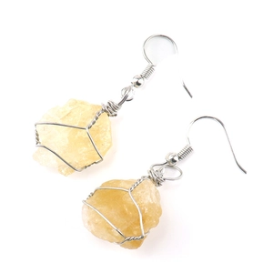 Detailed wire-wrapped silver earrings with natural pale yellow raw stone crystals