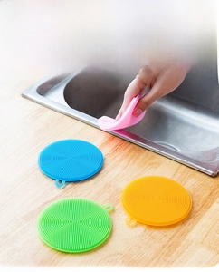 Detail of round silicone dish brushes in multiple colors with hanging loop and TPR bristles
