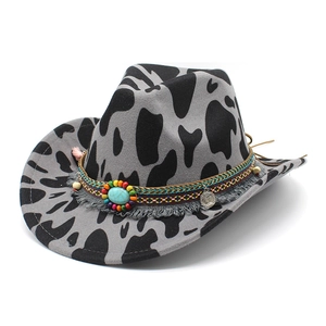Ethnic cow print cowboy hat with tribal beads and turquoise stone on grey felt