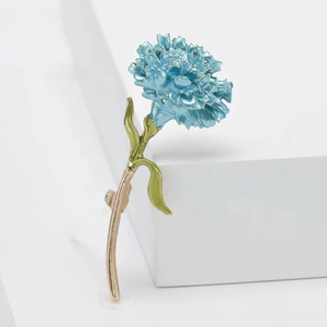 Artistic carnation flower brooch in blue enamel with green leaves and gold stem base