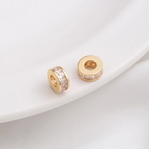 Macro view of 14K gold filled wheel spacer bead with cubic zirconia stones for DIY jewelry
