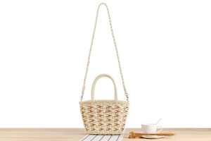 Close-up of hand-woven geometric pattern on tote bag with leather strap and handle