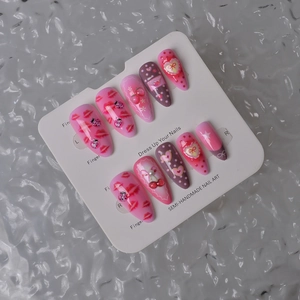 Detail view of 10pc handmade almond nails with 3D cherry and red lip heart patterns
