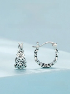 Macro shot of S925 sterling silver hoop earrings with hollow heart pattern and zircons