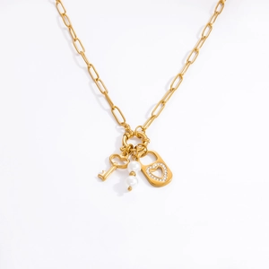 Gold paperclip chain necklace with heart key, pearl charms, and rhinestone lock pendant
