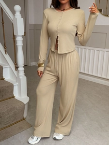Elegant beige two-piece resort set with long-sleeved button shirt and wide-leg trousers