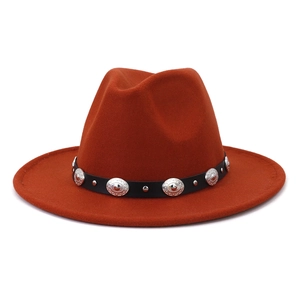 Orange wool jazz fedora hat with black leather belt and silver metal studs on white background