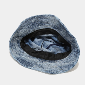 Detail view of washed denim bucket hat interior with adjustable drawstring and sweatband