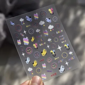 Macro shot of 3D embossed nail stickers featuring rainbow smiles and clouds on fingers