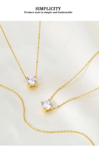 Macro detail of two gold plated titanium necklaces with four-prong set round zircon pendants