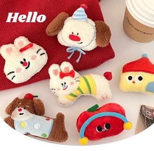 Macro shot of cute plush cartoon animal hair clips with detailed hand-stitched embroidery