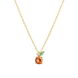 Macro shot of a minimalist gold apple pendant necklace with orange and green crystals