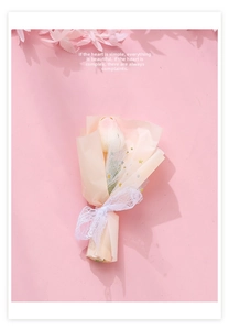 Close-up of a pink tulip bouquet gift with lace ribbon and elegant white mesh wrap