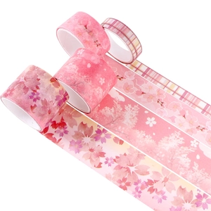 Detail of four cherry blossom themed washi tape rolls with gold foil and floral patterns