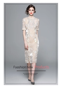Detail of champagne lace embroidery on qipao dress with traditional tassel buttons