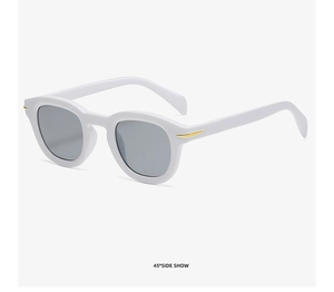 Detail view of white full-frame sunglasses with gold decorative bars from 45-degree angle