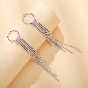Detail shot of silver tassel earrings with sparkling rhinestones and elegant ring hook