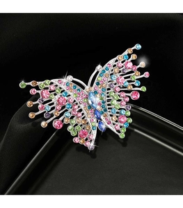 Close-up of vintage butterfly brooch with colorful rhinestones on silver metal base