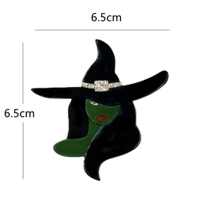 Detail view of a witch brooch with size 6.5cm x 6.5cm, enamel and metal material