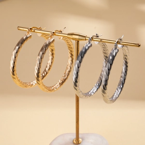 Geometric spiral textured round hoop earrings in gold and silver metallic finishes