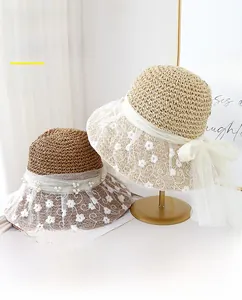 Detail of crochet straw hat with floral lace embroidery, pearls and UPF 50+ sun protection