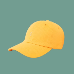 Close-up detail of white embroidered C letter on vibrant yellow cotton baseball cap