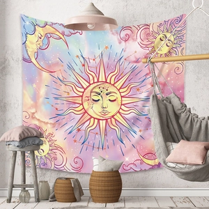 Detail of bohemian sun and moon tapestry on a textured wall in a cozy room decor