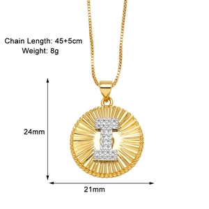Detailed view of gold plated round pendant with pave inlaid letter I and beaded edge