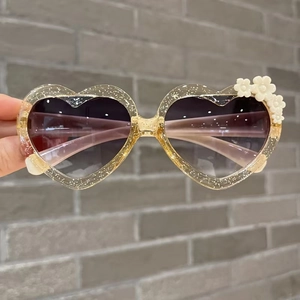Kids heart-shaped glitter sunglasses with white flower accents and dark grey lenses