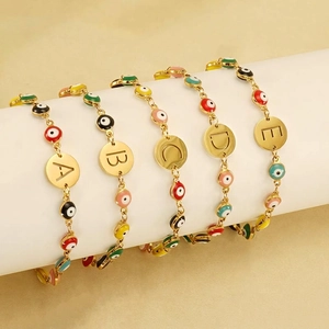 Gold-plated Evil Eye beaded bracelets with personalized initial charms A-E on display
