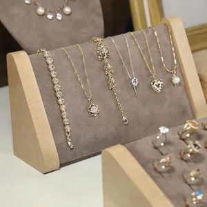 Solid wood jewelry display stand with golden rings, necklaces and elegant pendants