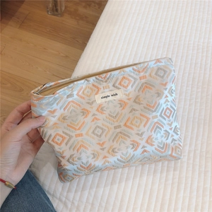 Macro view of geometric pattern storage bag with a zipper and Simple Wish fabric patch