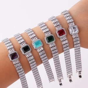 Macro detail of rectangle cut zircon bracelets in six vibrant colors worn on wrist