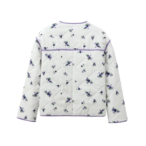 Close-up of quilted cotton jacket featuring purple floral prints and contrast piping edges