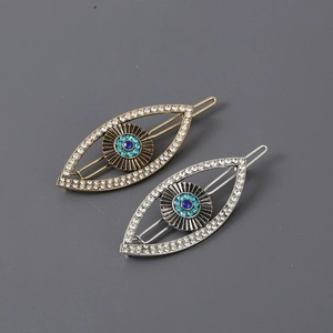 Exaggerated evil eye hair clips with rhinestones and blue crystals in gold and silver