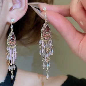 Bohemian style water drop earrings with reddish-brown gems and long crystal tassels